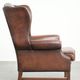 Comfortable cowhide wingback armchair in English style with a timeless look