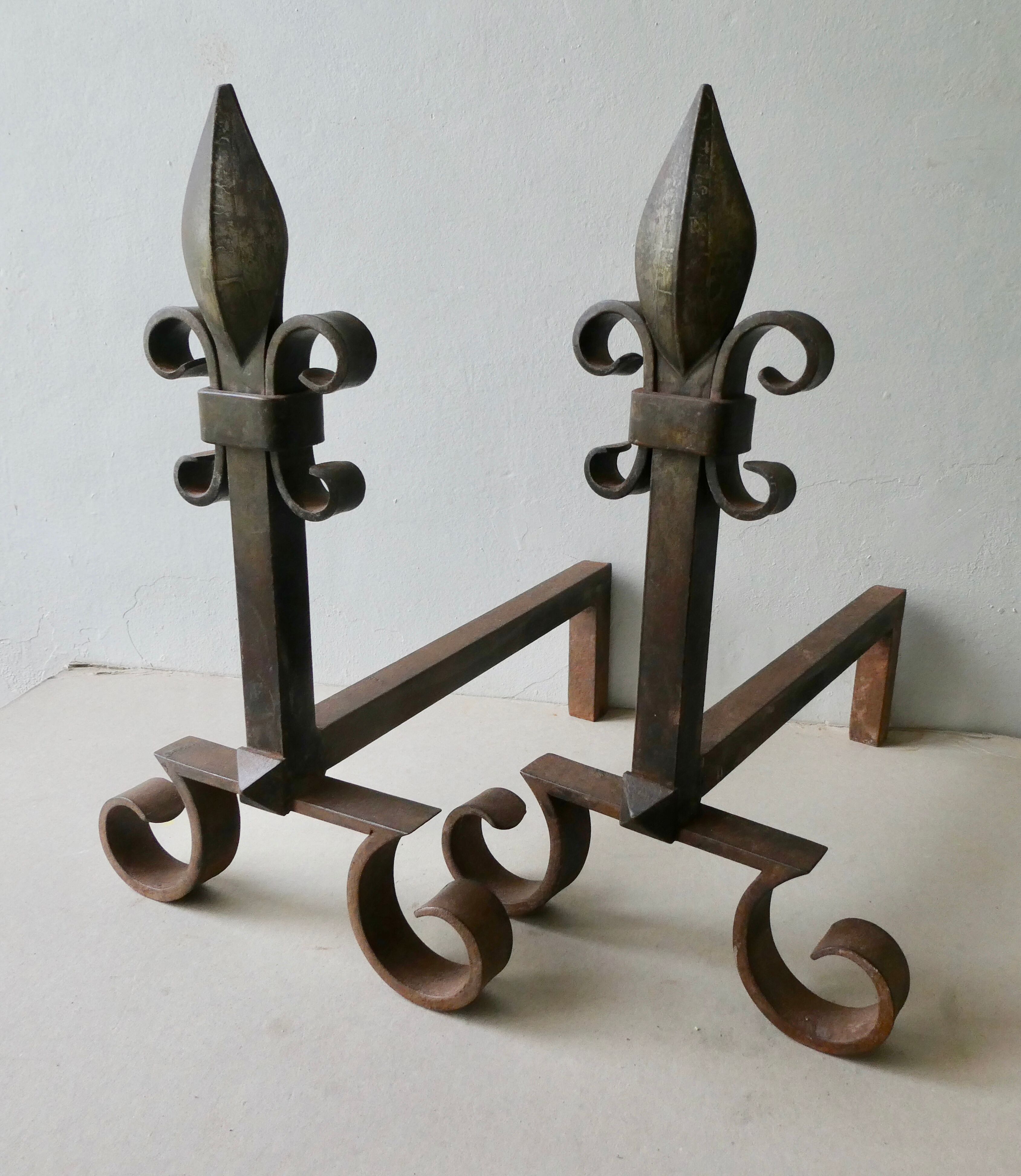 Pair of cast iron and beaten iron chenets, fleurs-de-lis