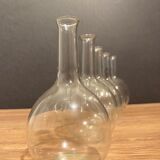 Suite of 5 bakings, bottles with long glass neck