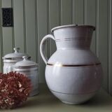 Old enamelled metal jug with gold trim.