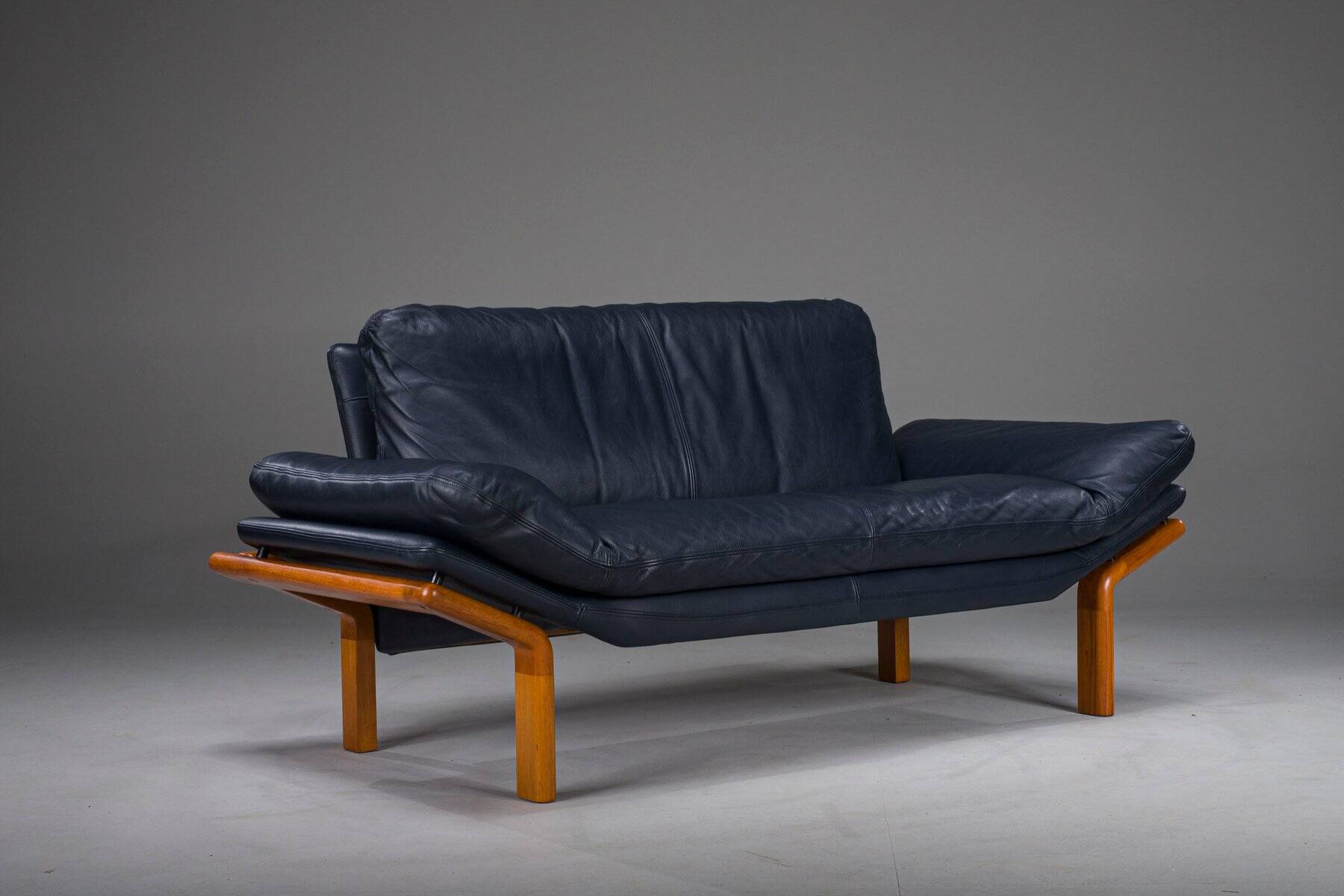 Danish teak and navy blue leather 2-seater sofa from Komfort, 1970s