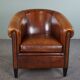Club armchair in sheepskin with black piping