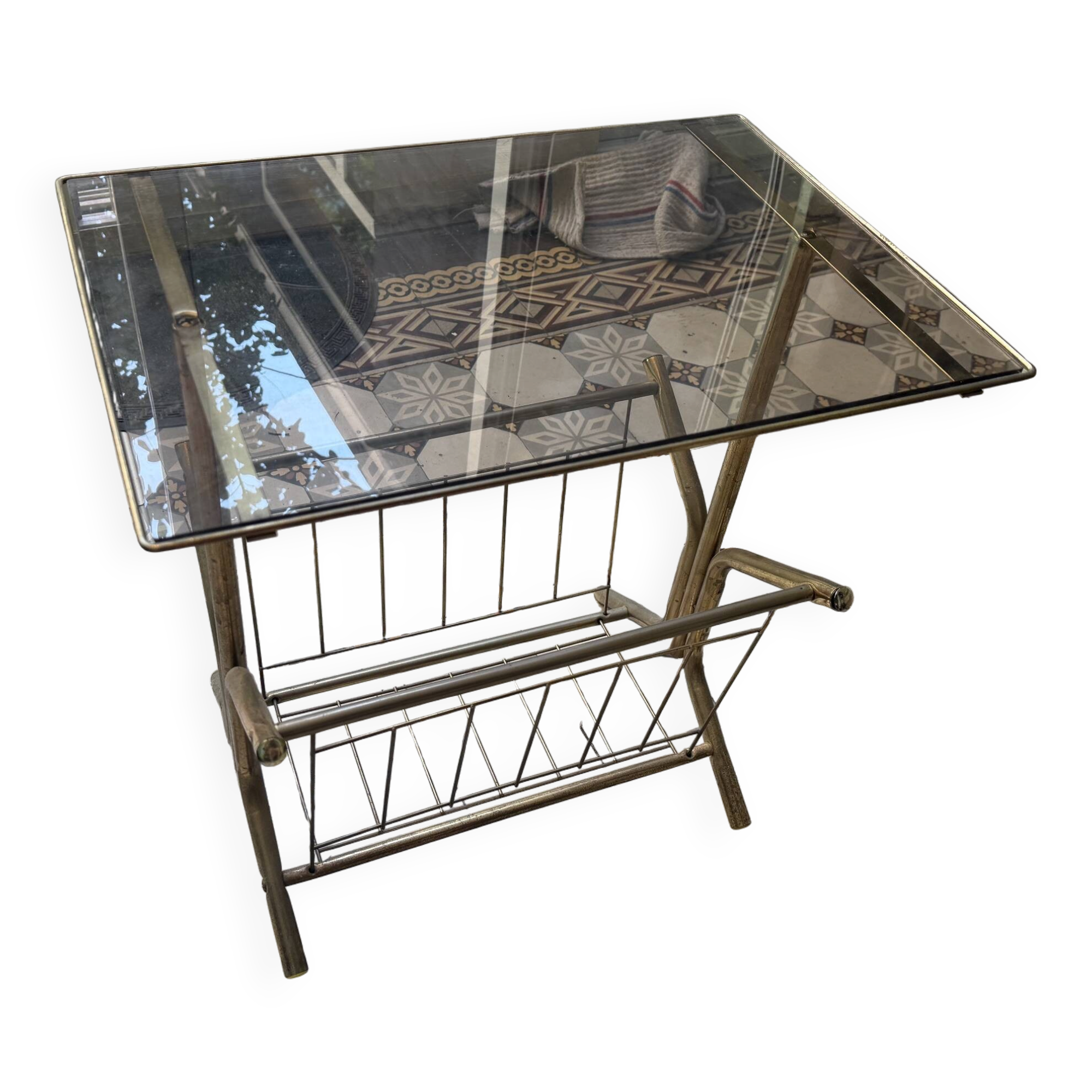Vintage style side table with magazine holder, gold metal and glass top.