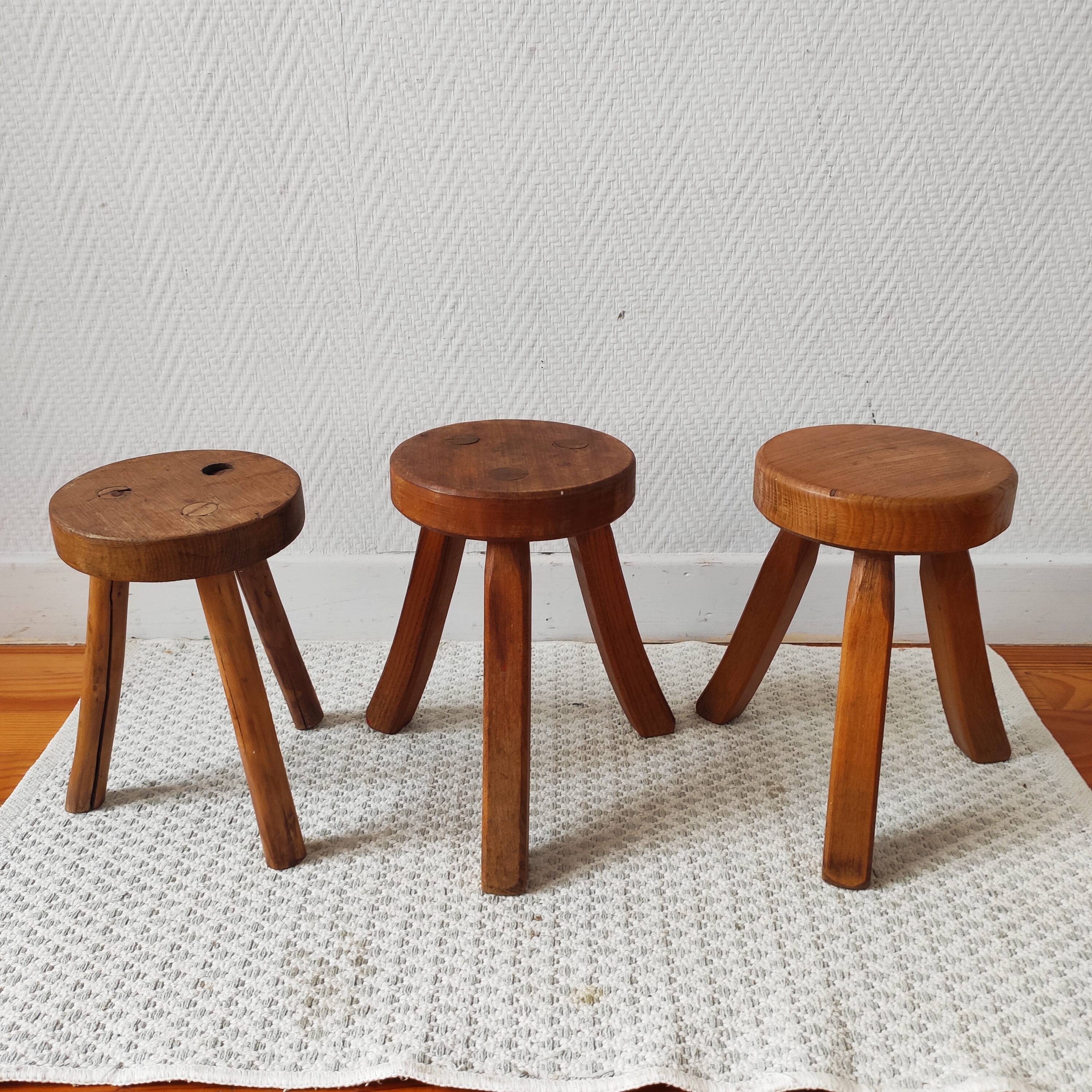 3 wooden tripod stools