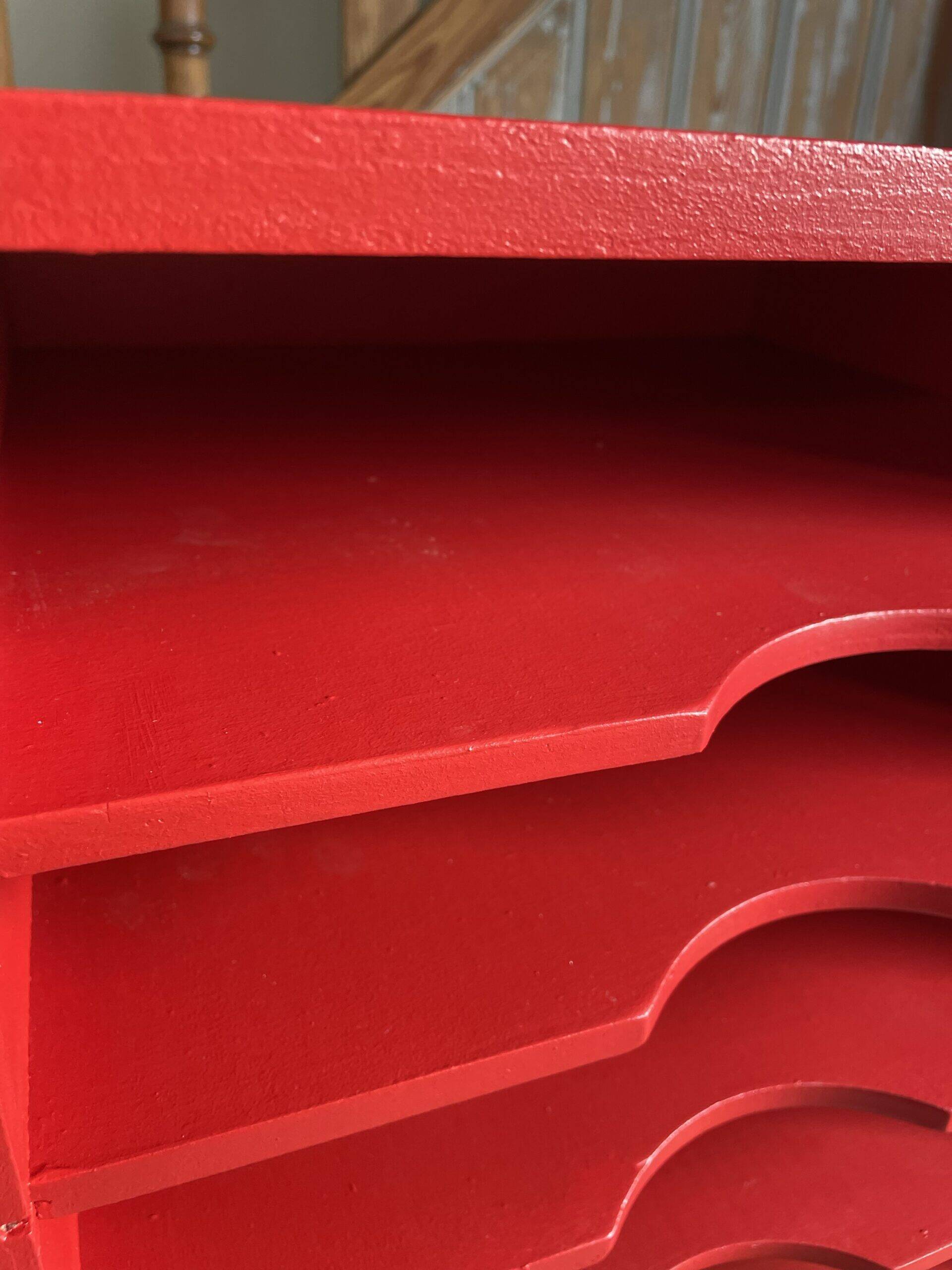 Vintage wooden magazine rack in red.