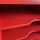 Vintage wooden magazine rack in red.