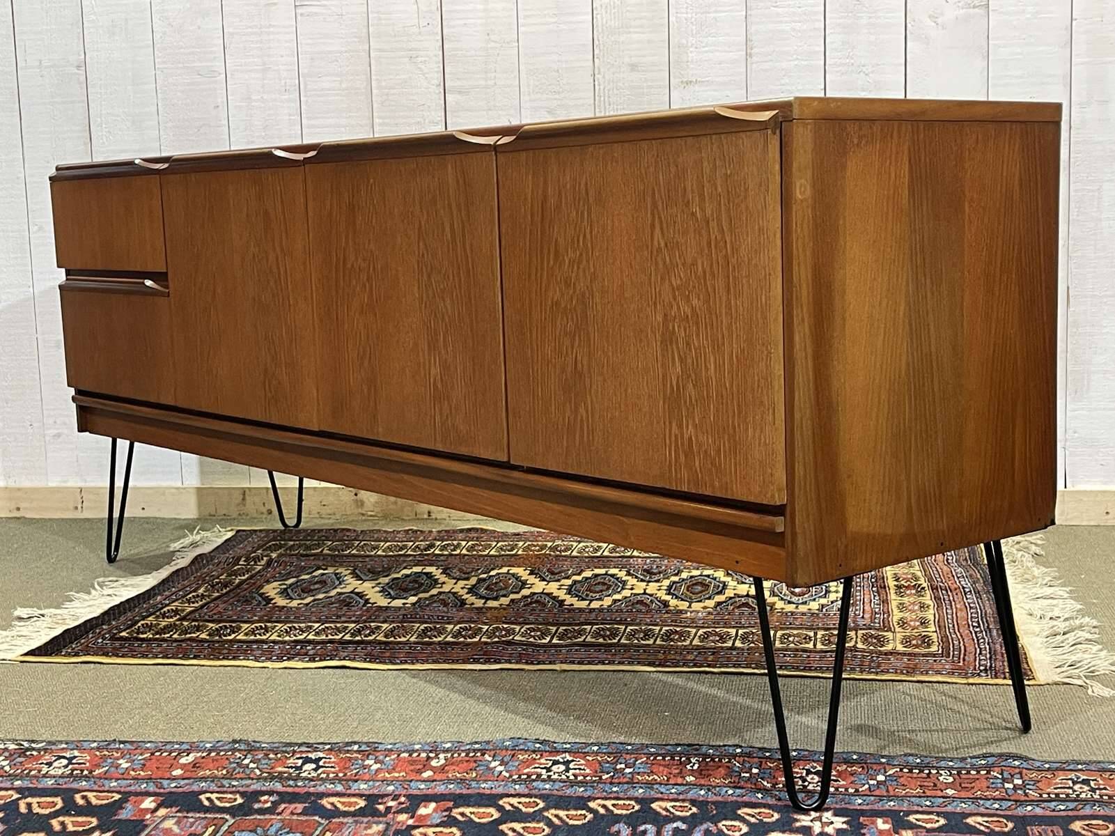1970s English enfilade in teak with splayed legs.