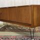 1970s English enfilade in teak with splayed legs.