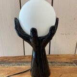 Lamp hands holding a globe
