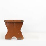 French rustic low church stool in terracotta painted wood, ca. 1900