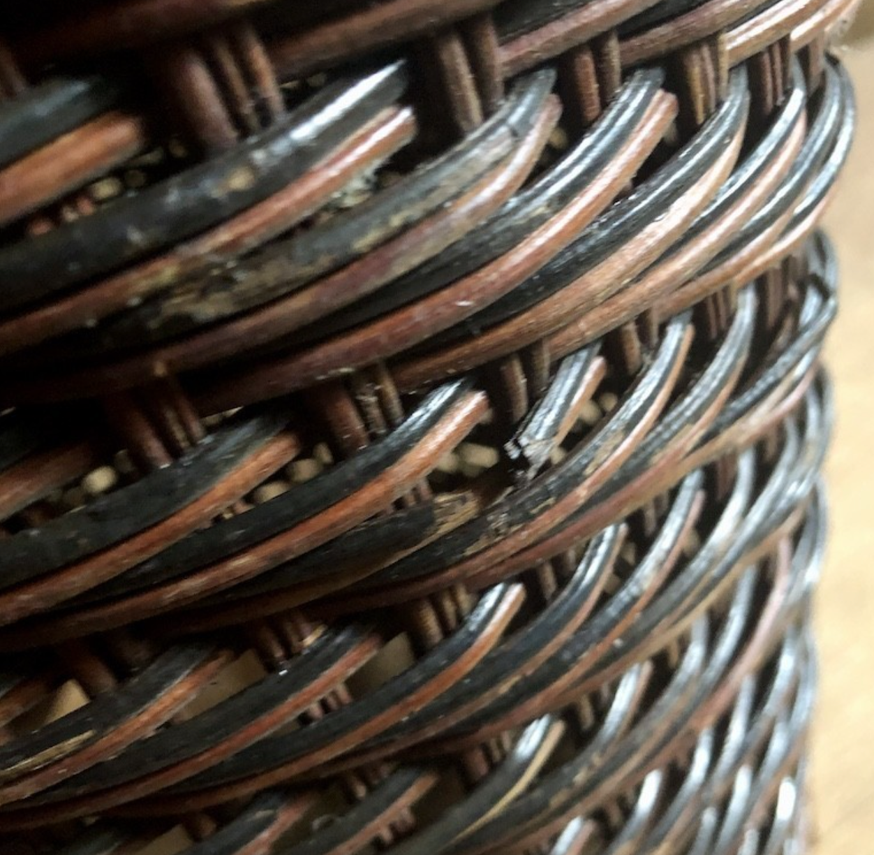 High basket in braided wicker