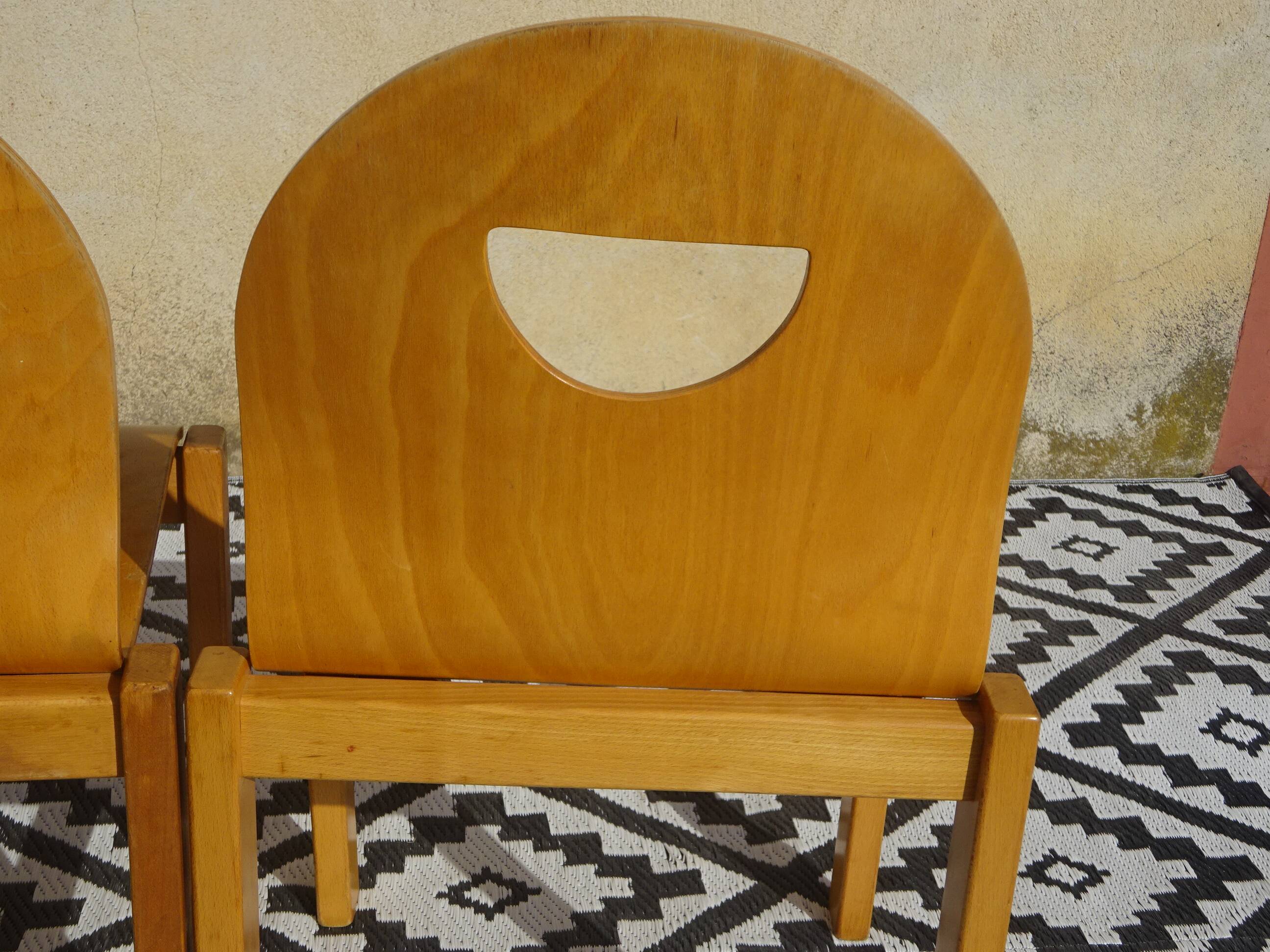 Pair of light wood chairs with post-formed seat and backrest.