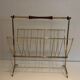 Brass and wood magazine rack, in the style of Cesare Lacca.
