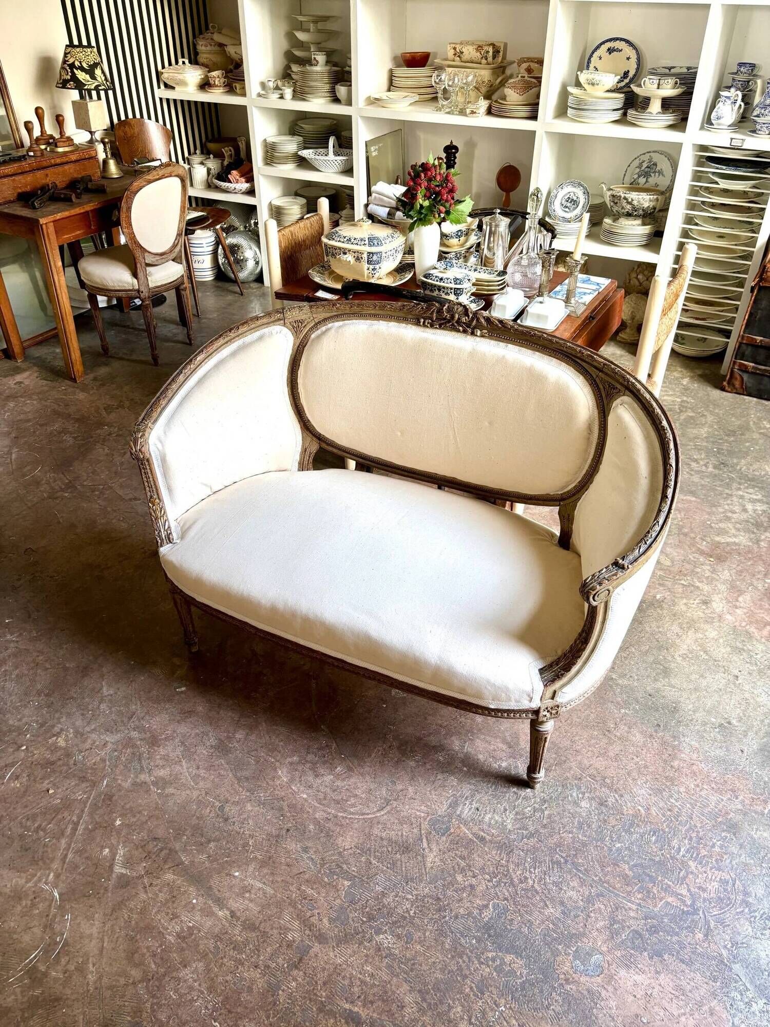 Two-seater basket bench in carved wood and beige mixed fabric, 18th century.