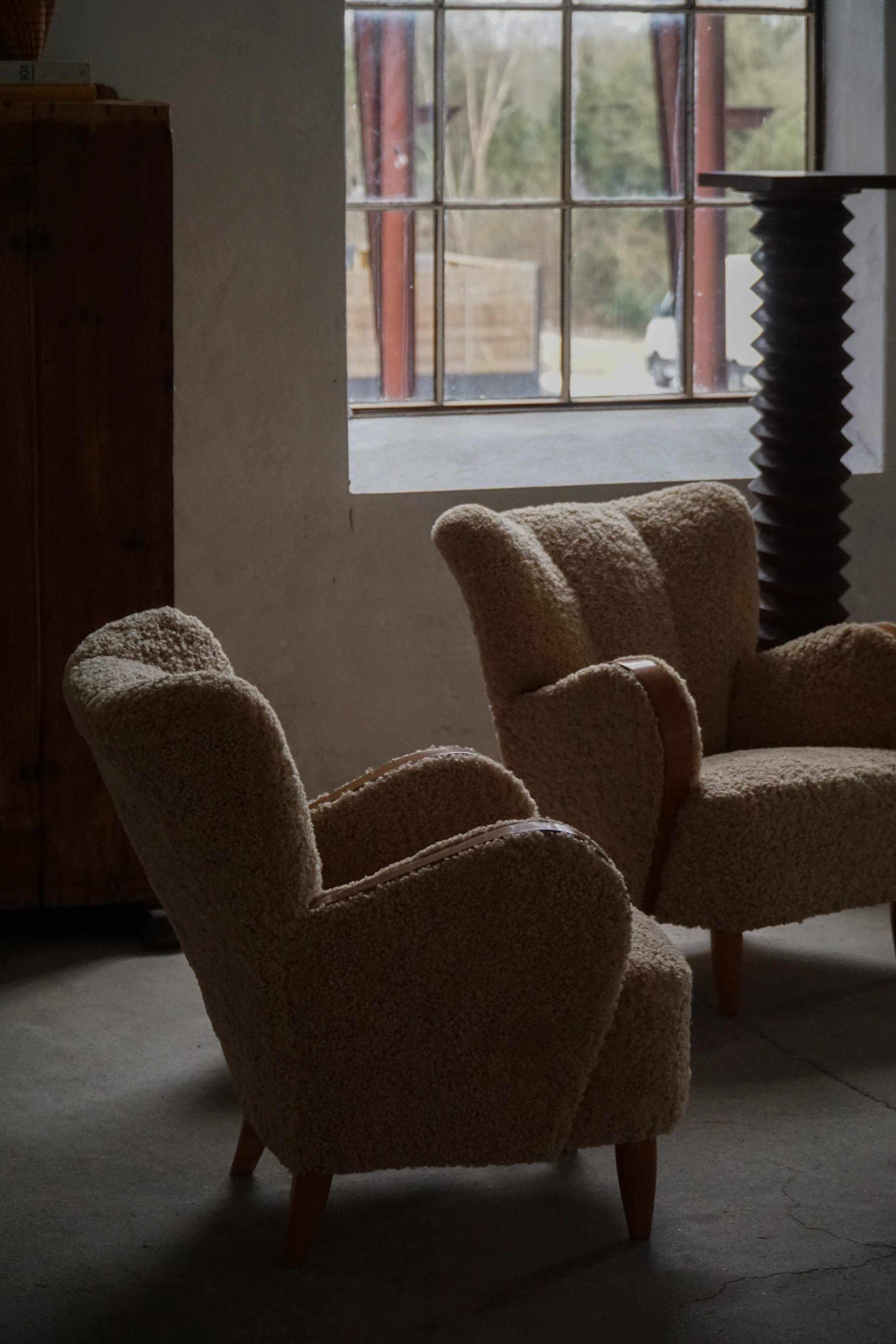 Pair of Danish Art Deco modern lounge chairs in sheepskin with lambswool and elm, 1940s.