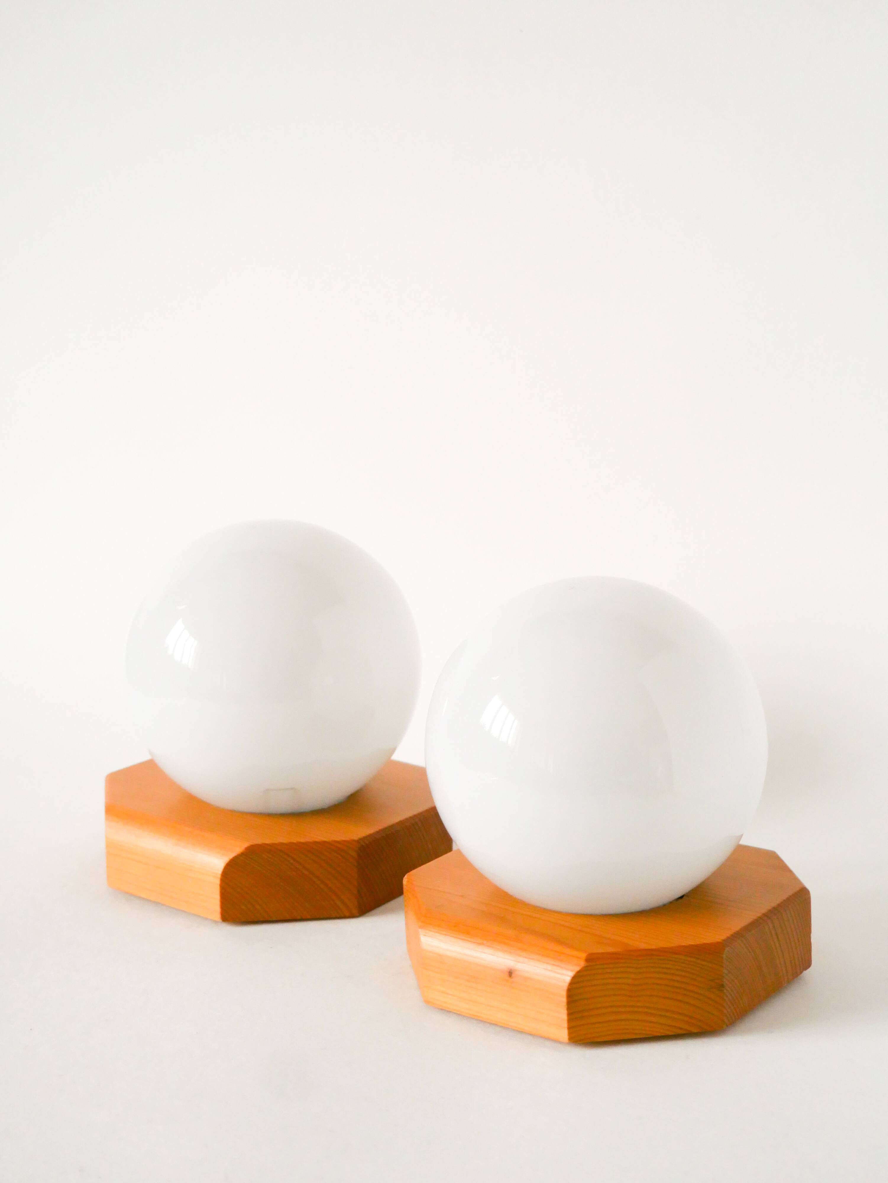 Pair of globe wall lights in opaline with a pine base, 1980.