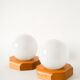 Pair of globe wall lights in opaline with a pine base, 1980.