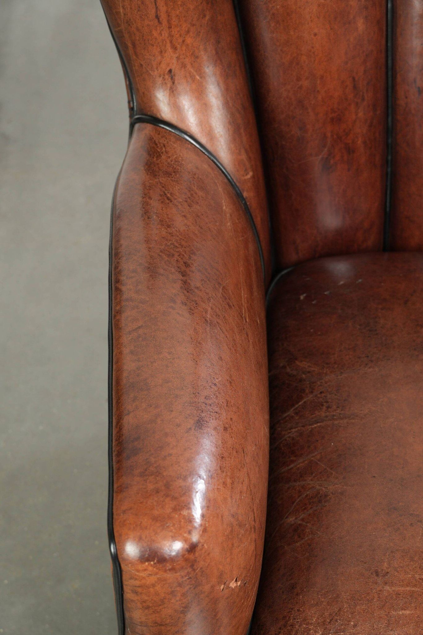 Unique sheepskin armchair with warm deep colours finished with black piping