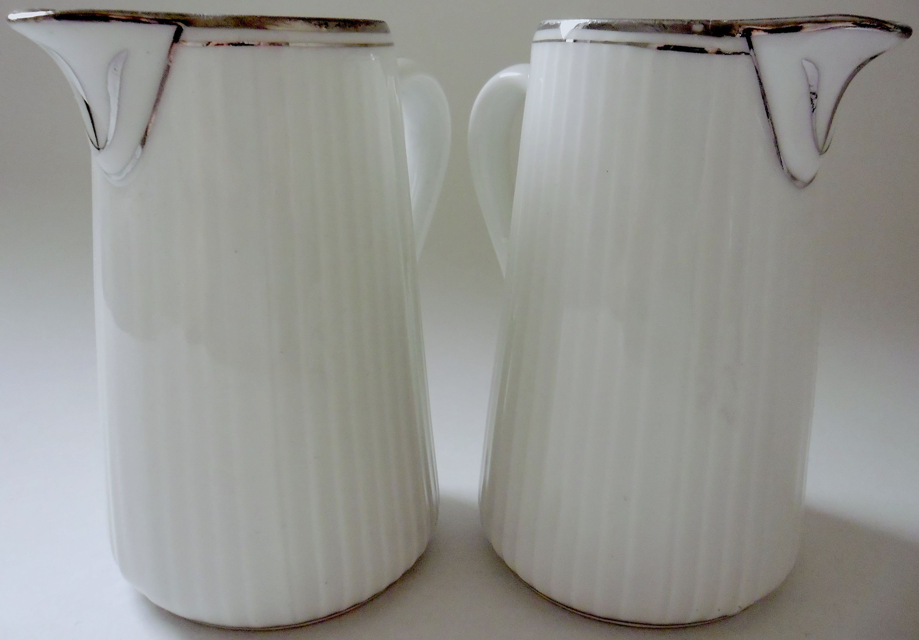 Pair of creamers in white porcelain enhanced with platinum