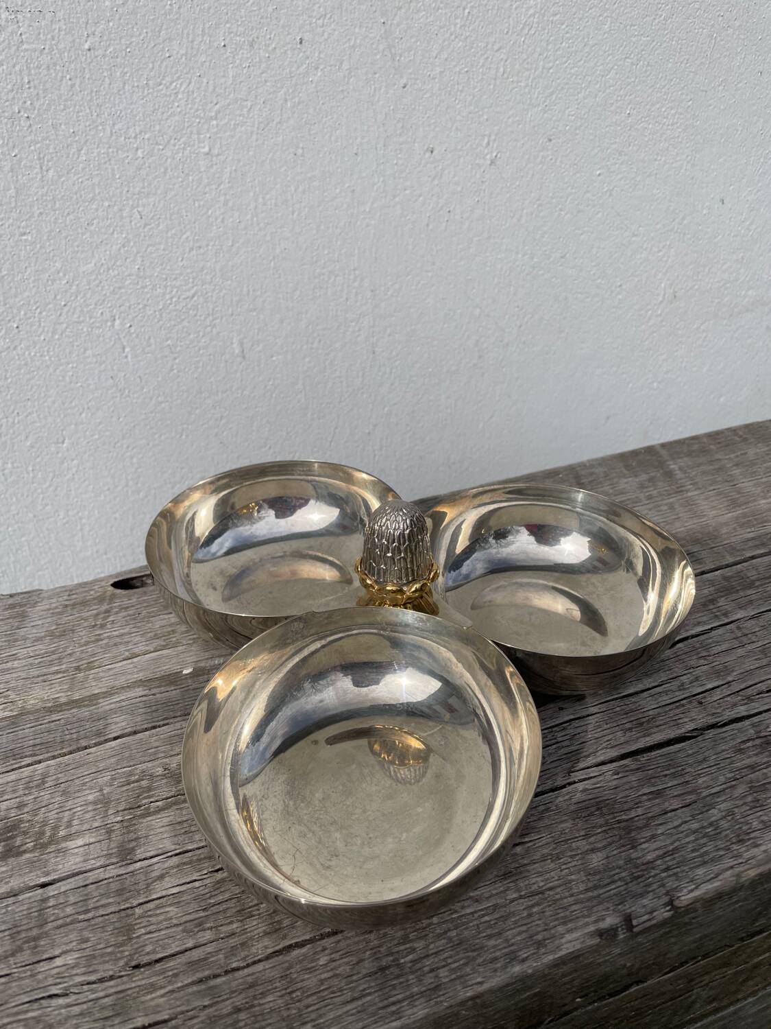 Silver-plated metal dish topped with an acorn