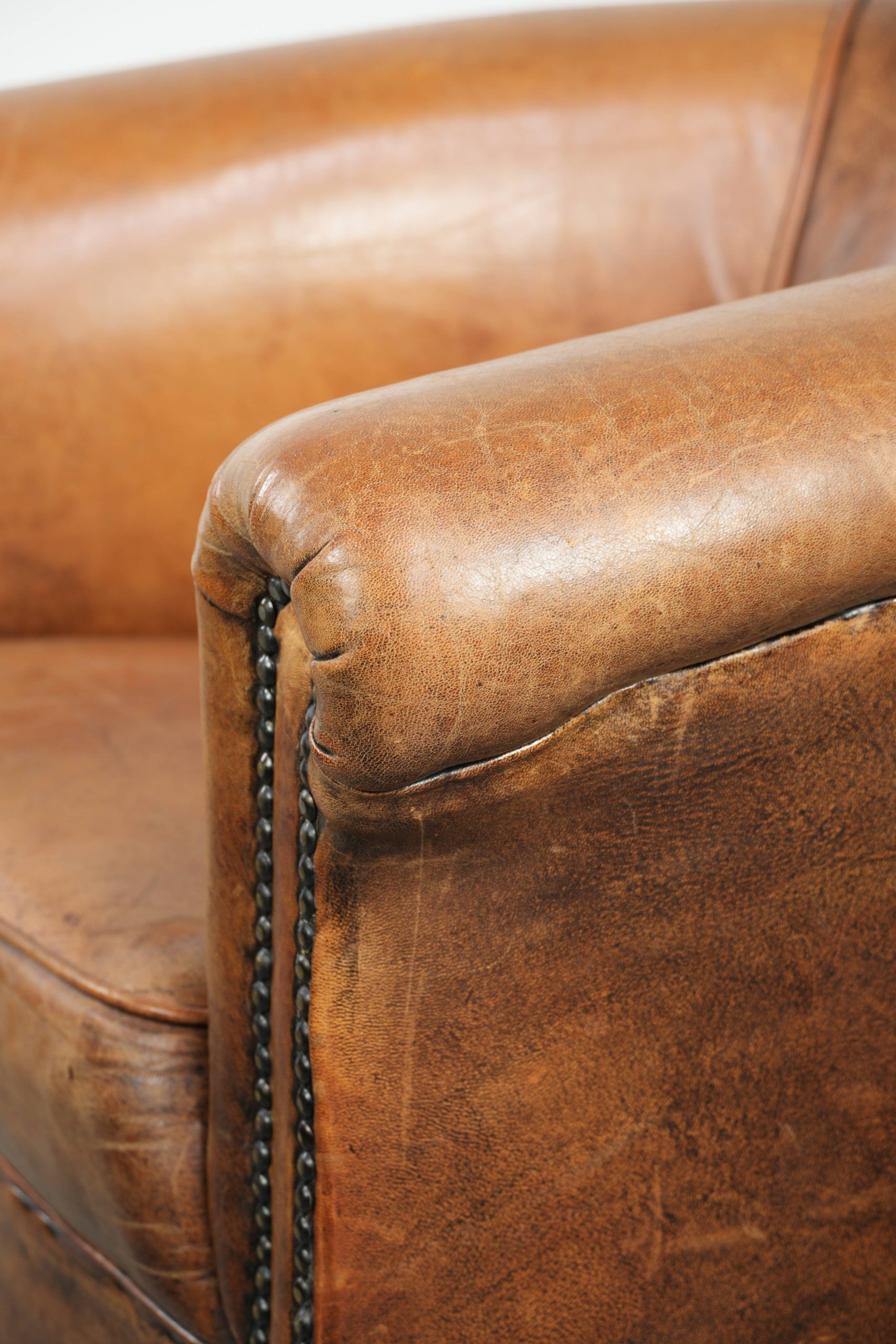 Vintage sheepskin club armchair in a subtle size with warm colours