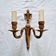 French Empire-style wall sconce or chandelier in bronze with an antique gold patina.