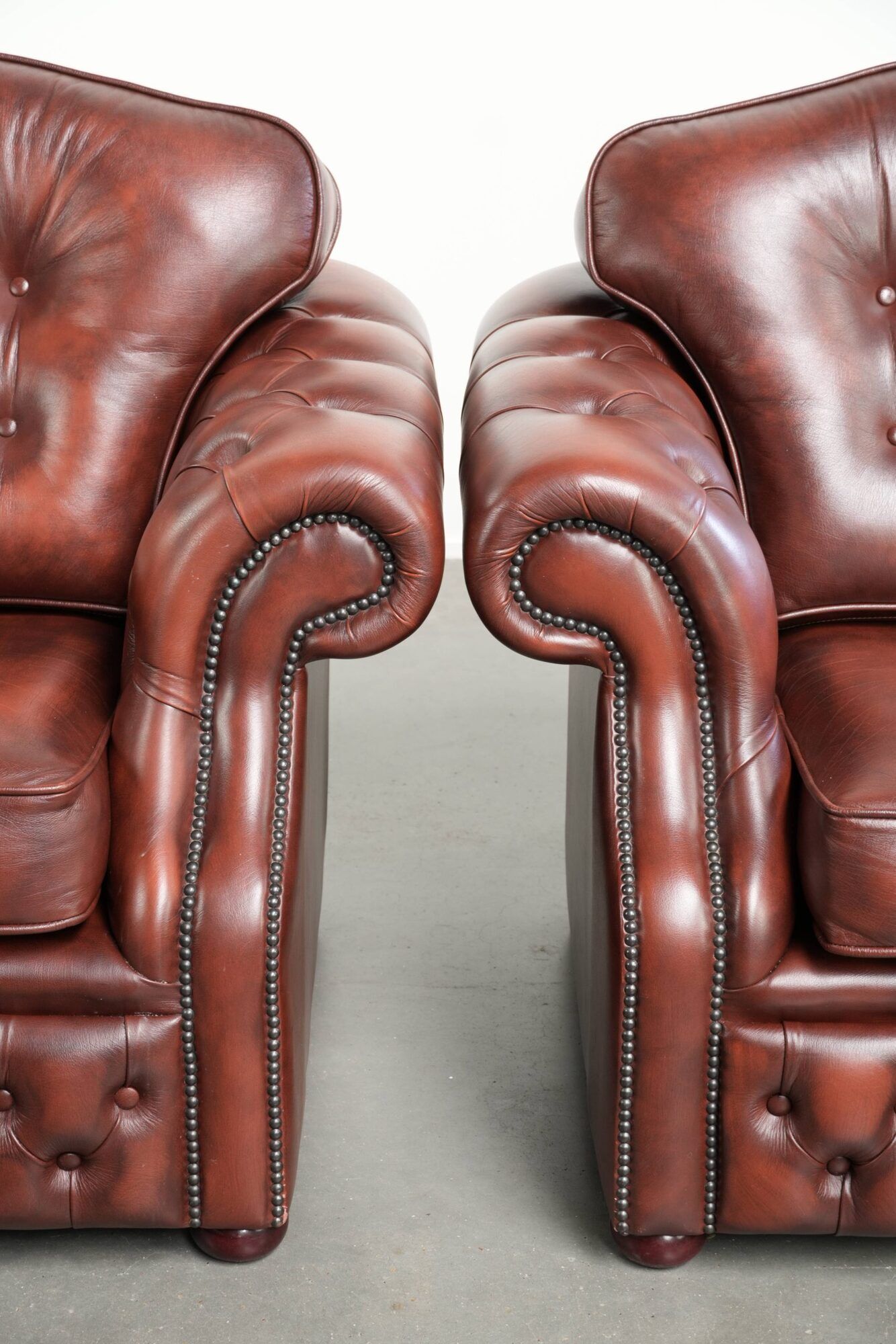 Vintage set of 2 cowhide leather Chesterfield armchairs in a brown colour