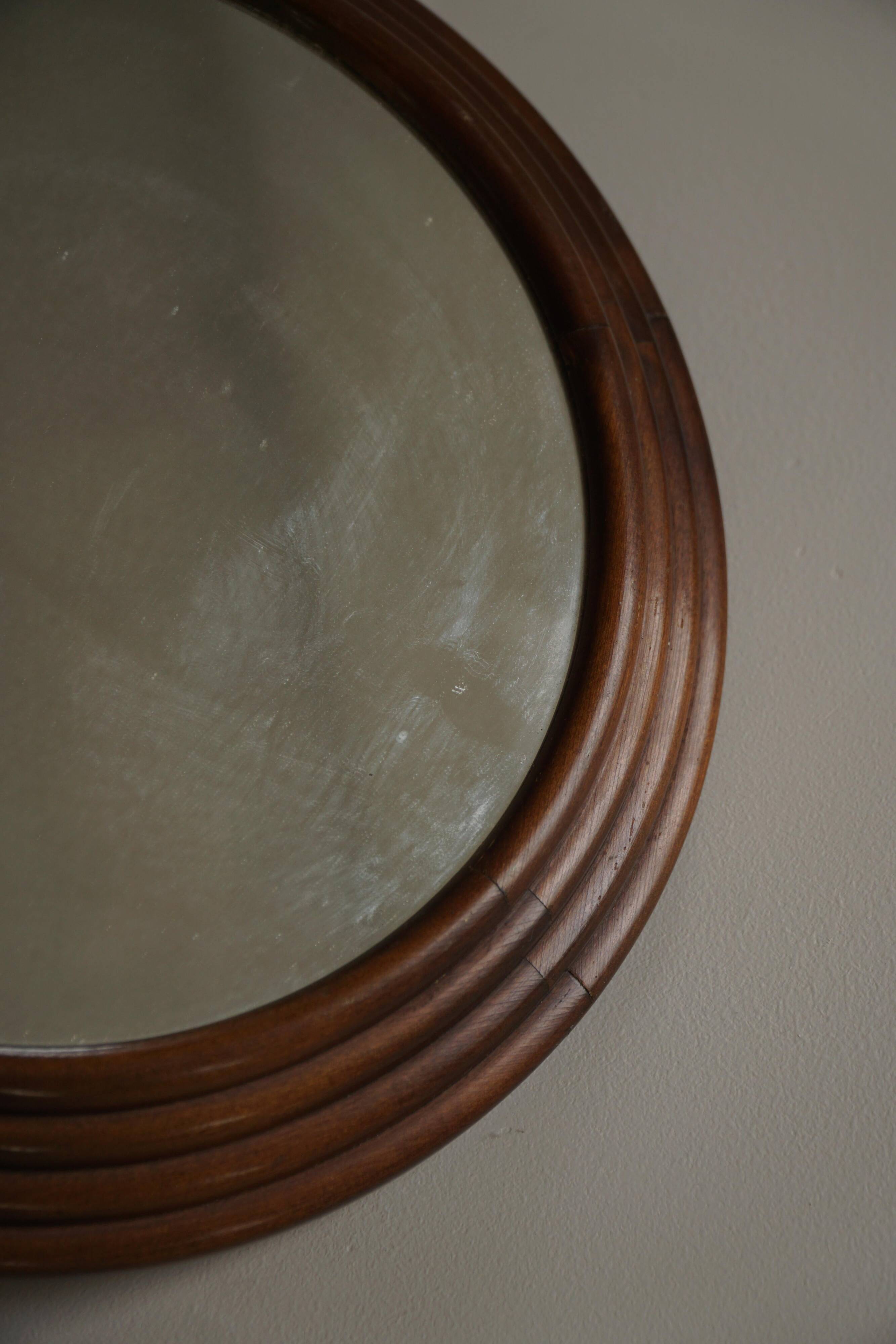 Round wooden wall decorative mirror, carved frame, mid-20th century, 1950s.