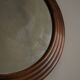 Round wooden wall decorative mirror, carved frame, mid-20th century, 1950s.