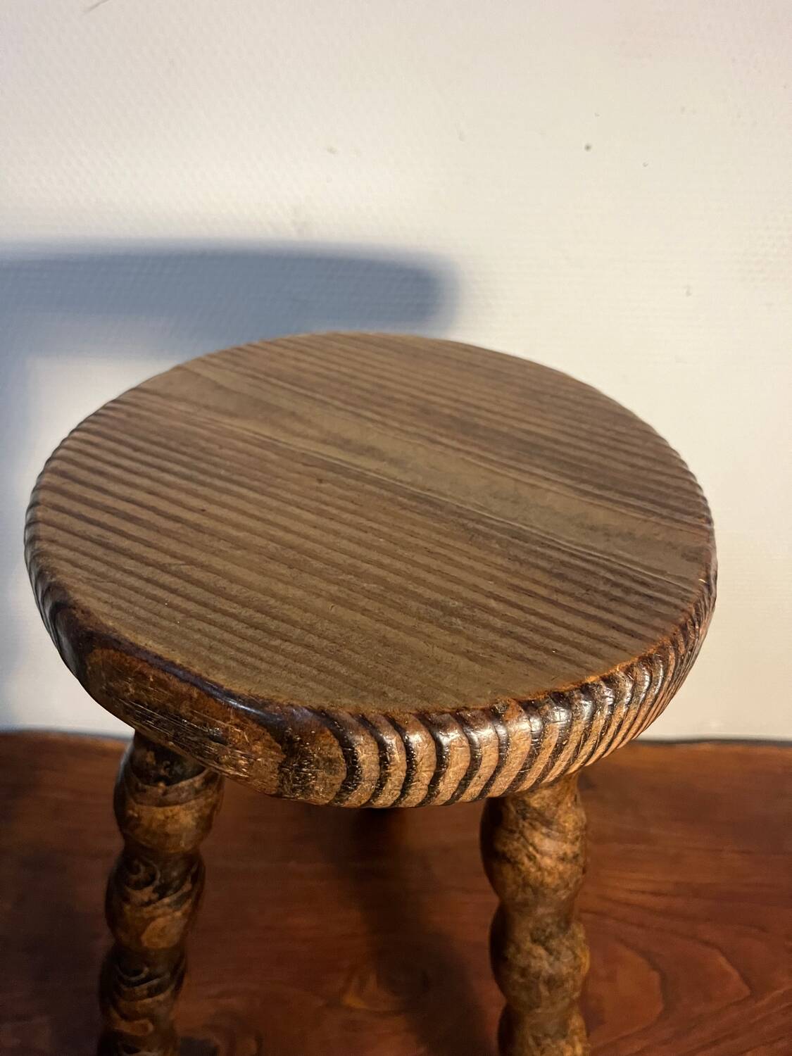 Round wooden tripod stool