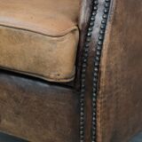 Vintage sheepskin club armchair with character and a beautiful patina
