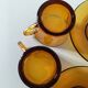5 vintage amber Duralex cups and saucers