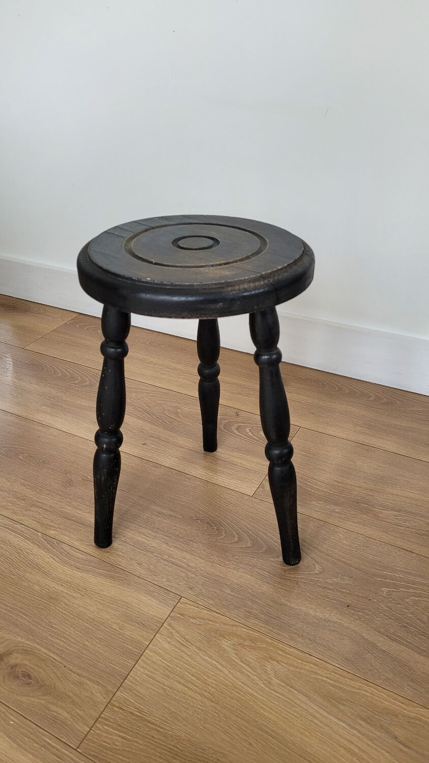 Black wooden tripod stool