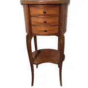 Oval bedside table in Louis XV style made of mahogany.