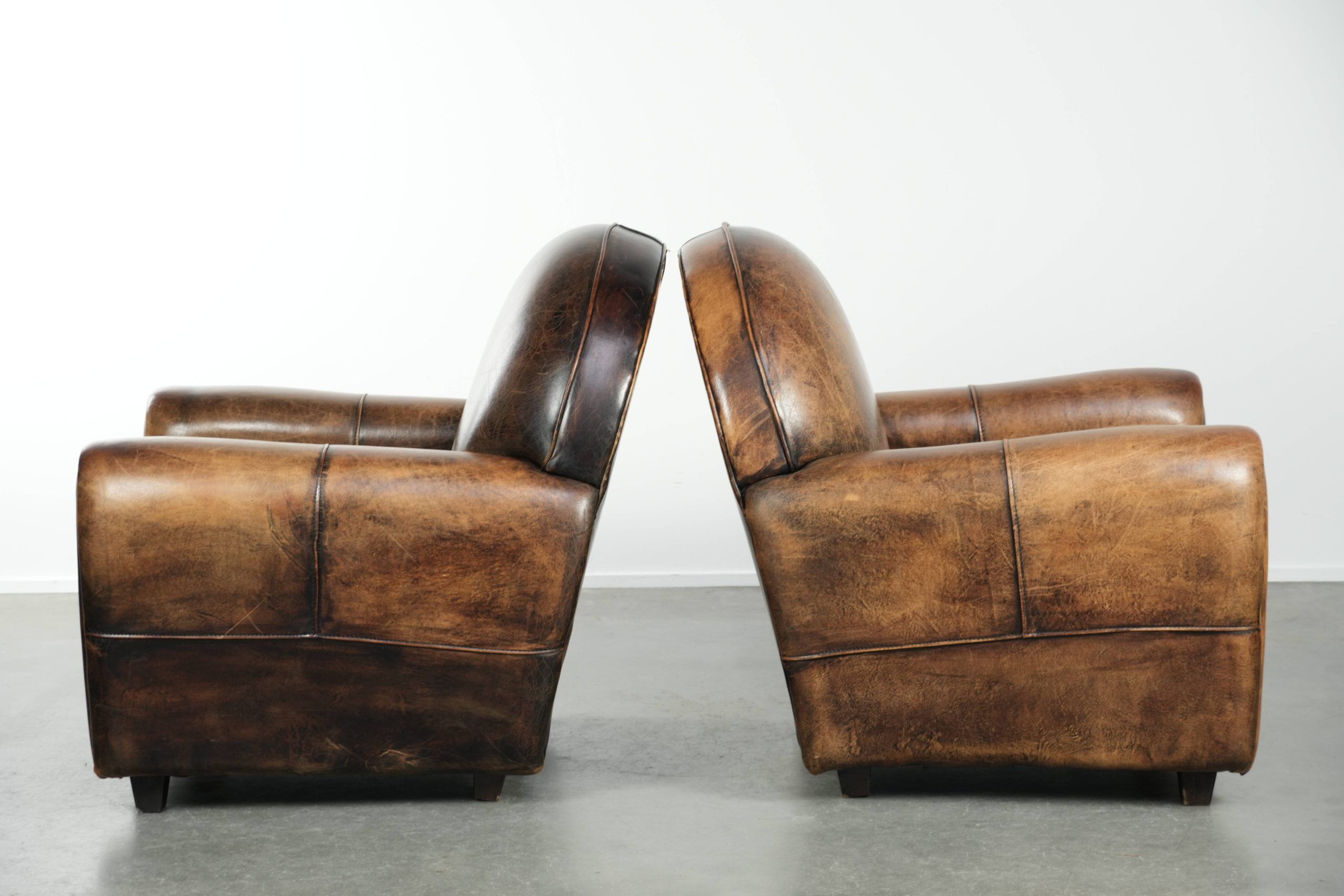 Set of two sheepskin Art Deco design armchairs with beautiful patina