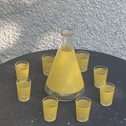 Liqueur set consisting of a glass carafe and 8 small yellow glasses