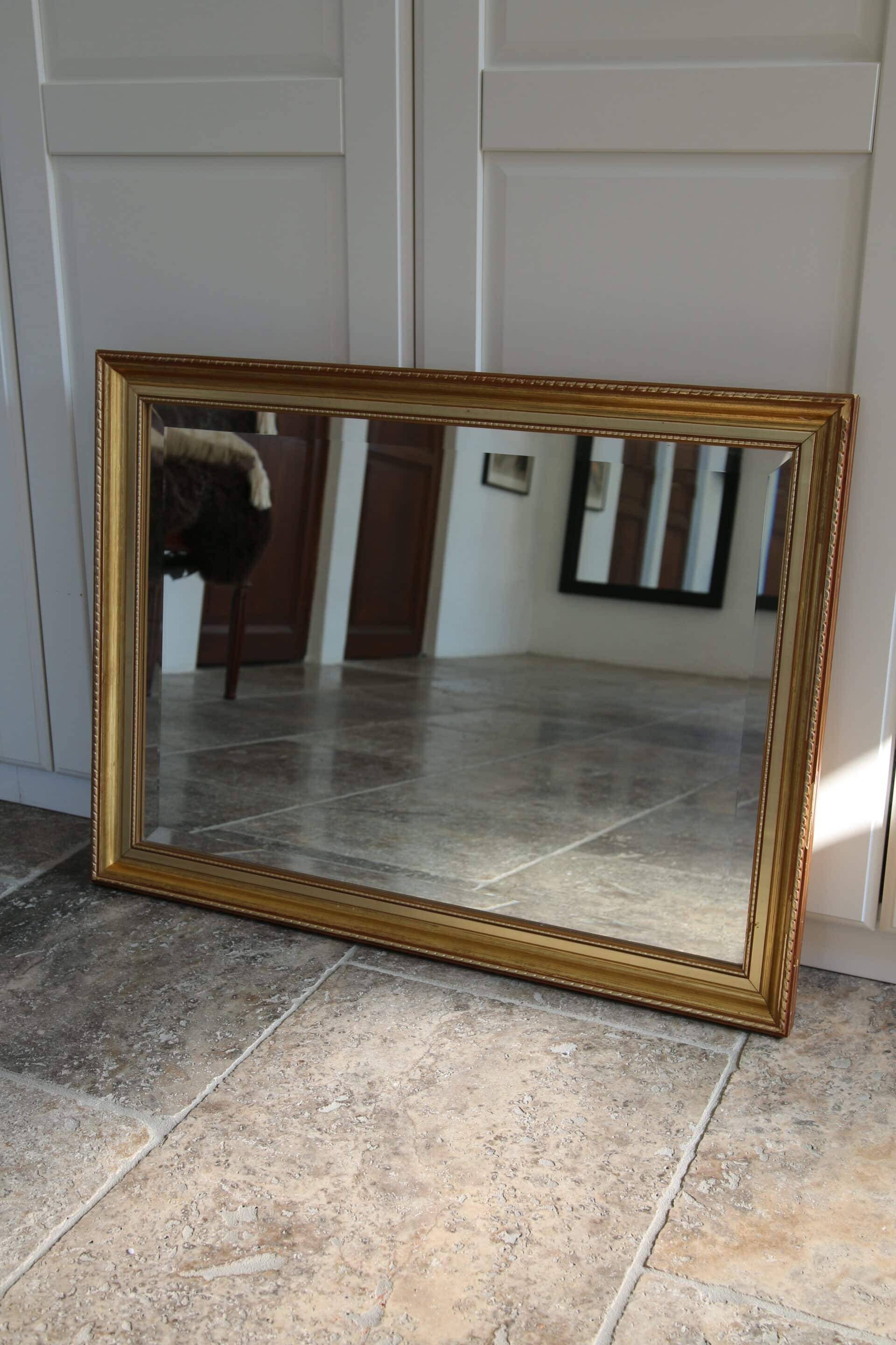 Large beveled mirror in carved wood