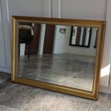 Large beveled mirror in carved wood