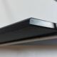 Mid-century vintage shelf in a loop shape, black glass and metal.