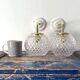 Set of two wall sconces in brass and glass