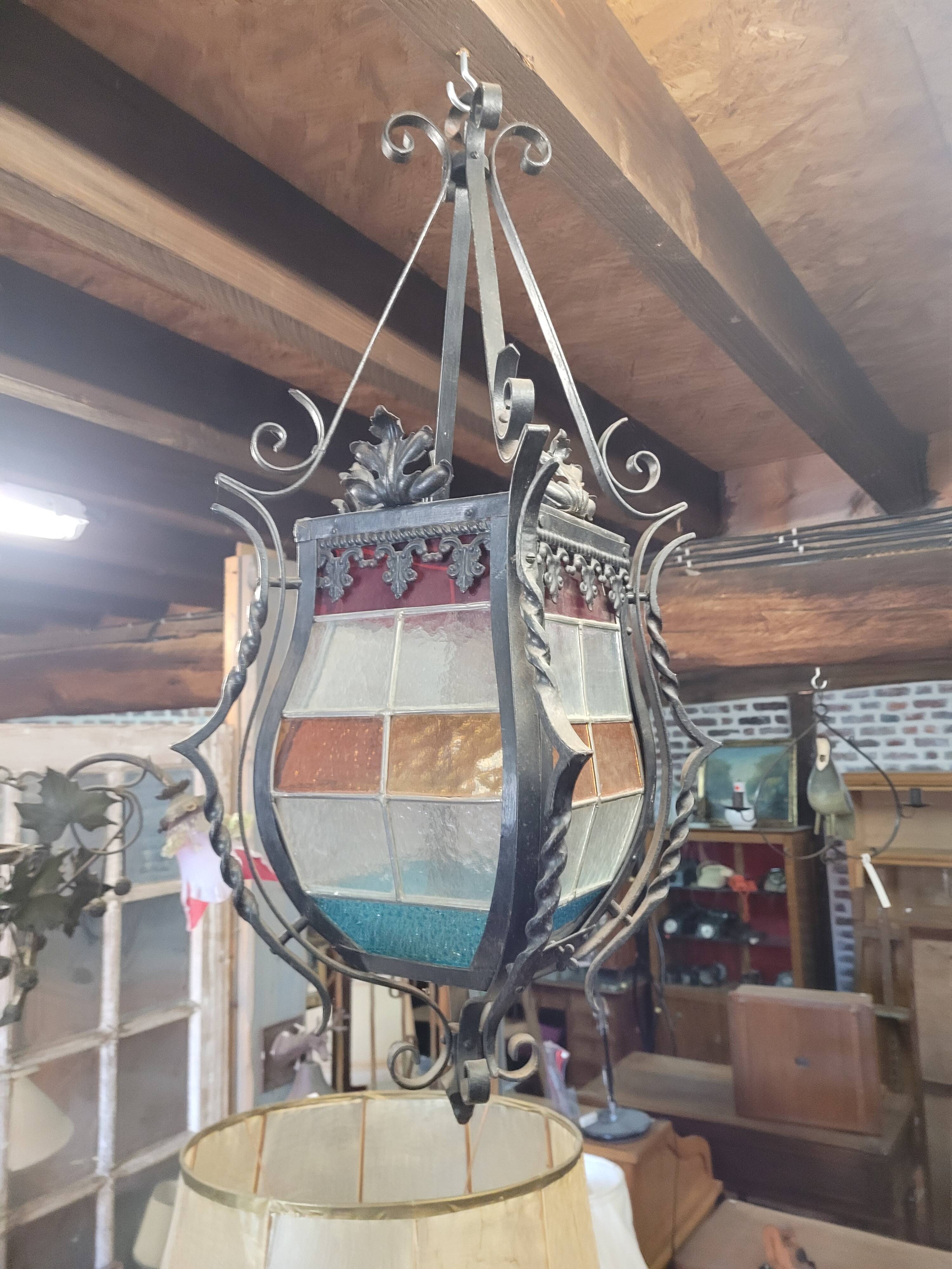 Wrought iron lantern with stained glass windows