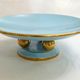 Art Deco modernist coupe, with a base of 3 spheres, in turquoise ceramic and gilding.