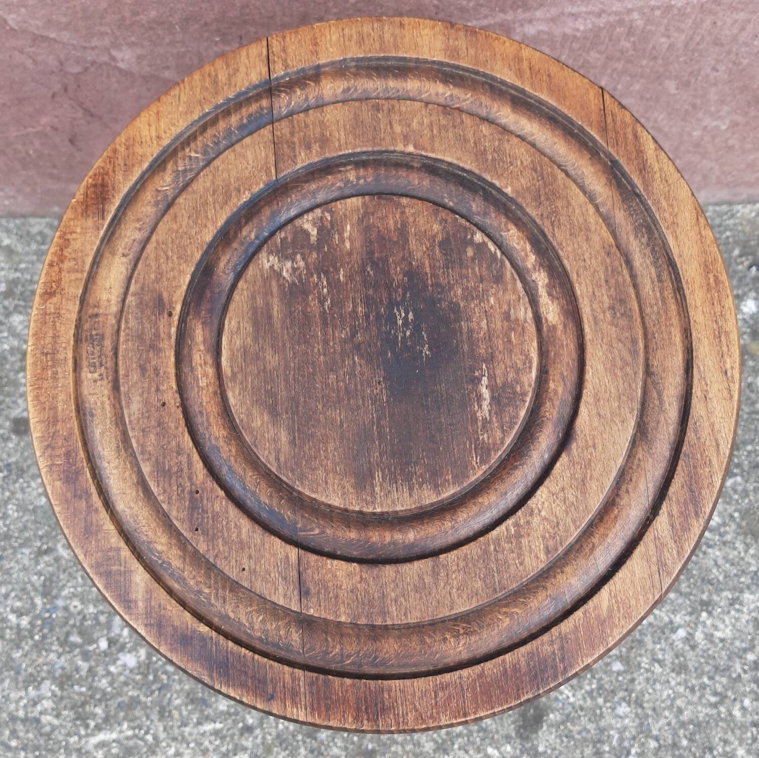 Low wooden tripod stool.