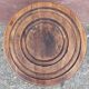 Low wooden tripod stool.