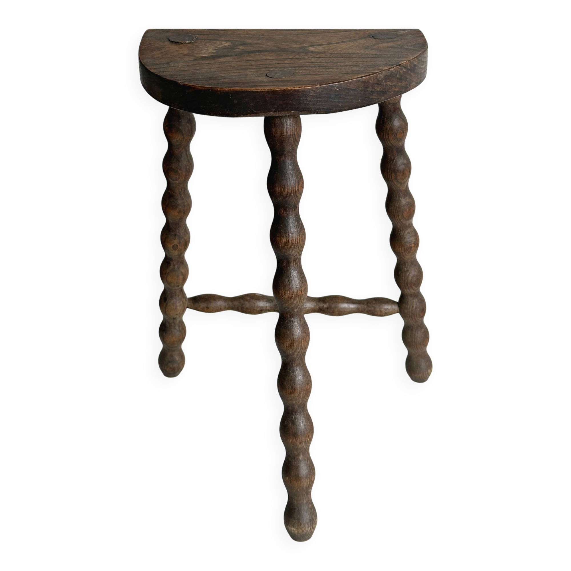Three-legged demi-lune stool made of turned wood
