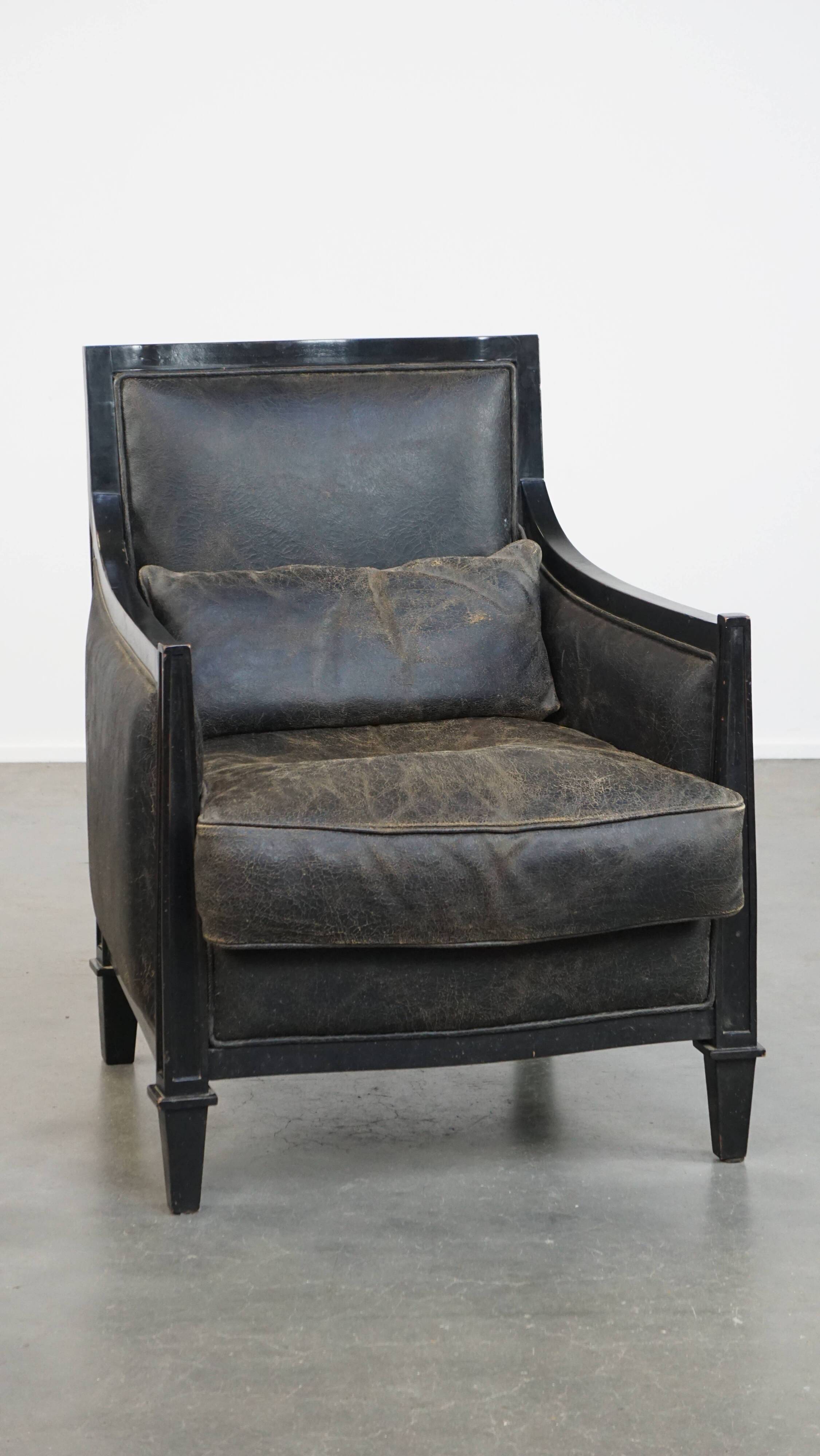 Armchair in black cowhide leather and wood with an Art Deco design