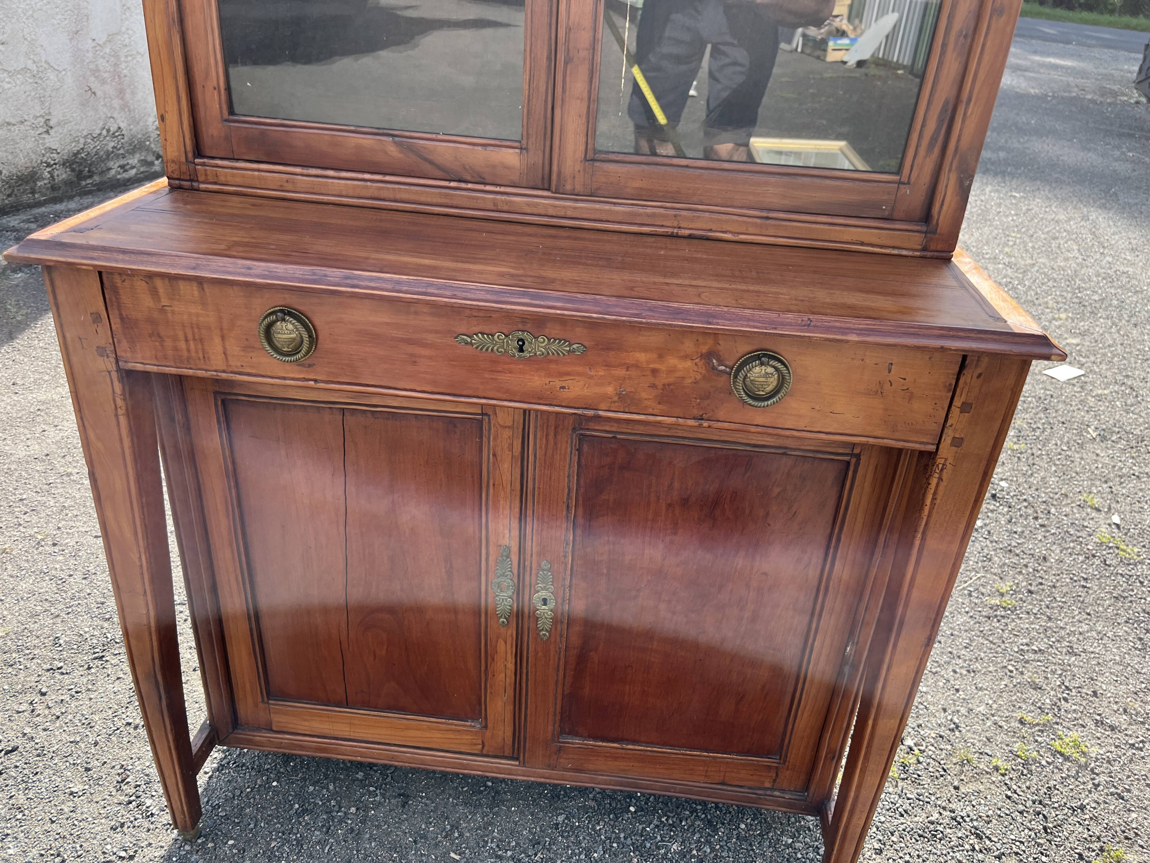Victorian English two-body buffet with cherry wood on marble display case from the 19th century.