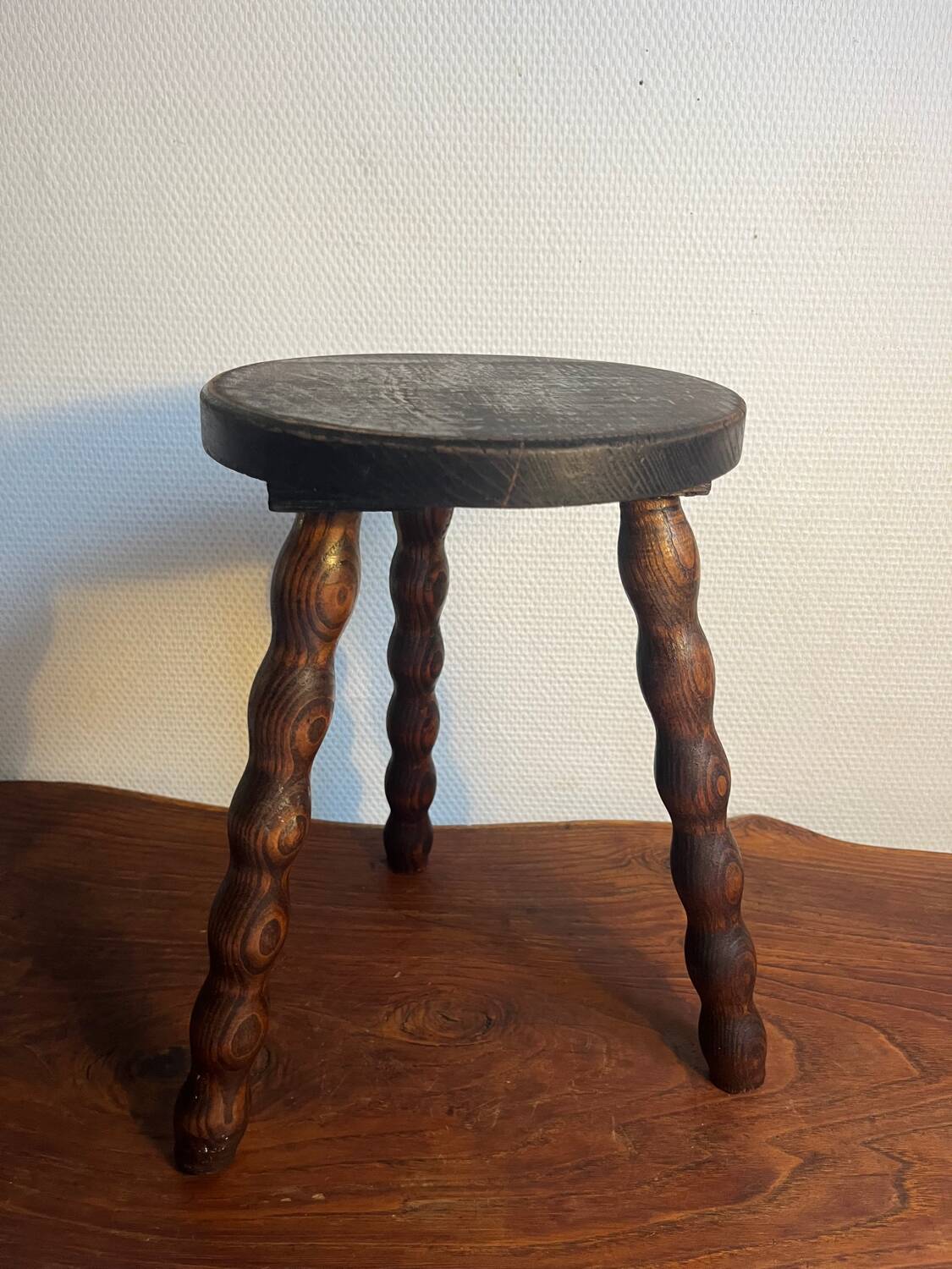 Round wooden tripod stool