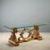 Antique coffee table in gilded wood with a glass top, Italy, 20th century.