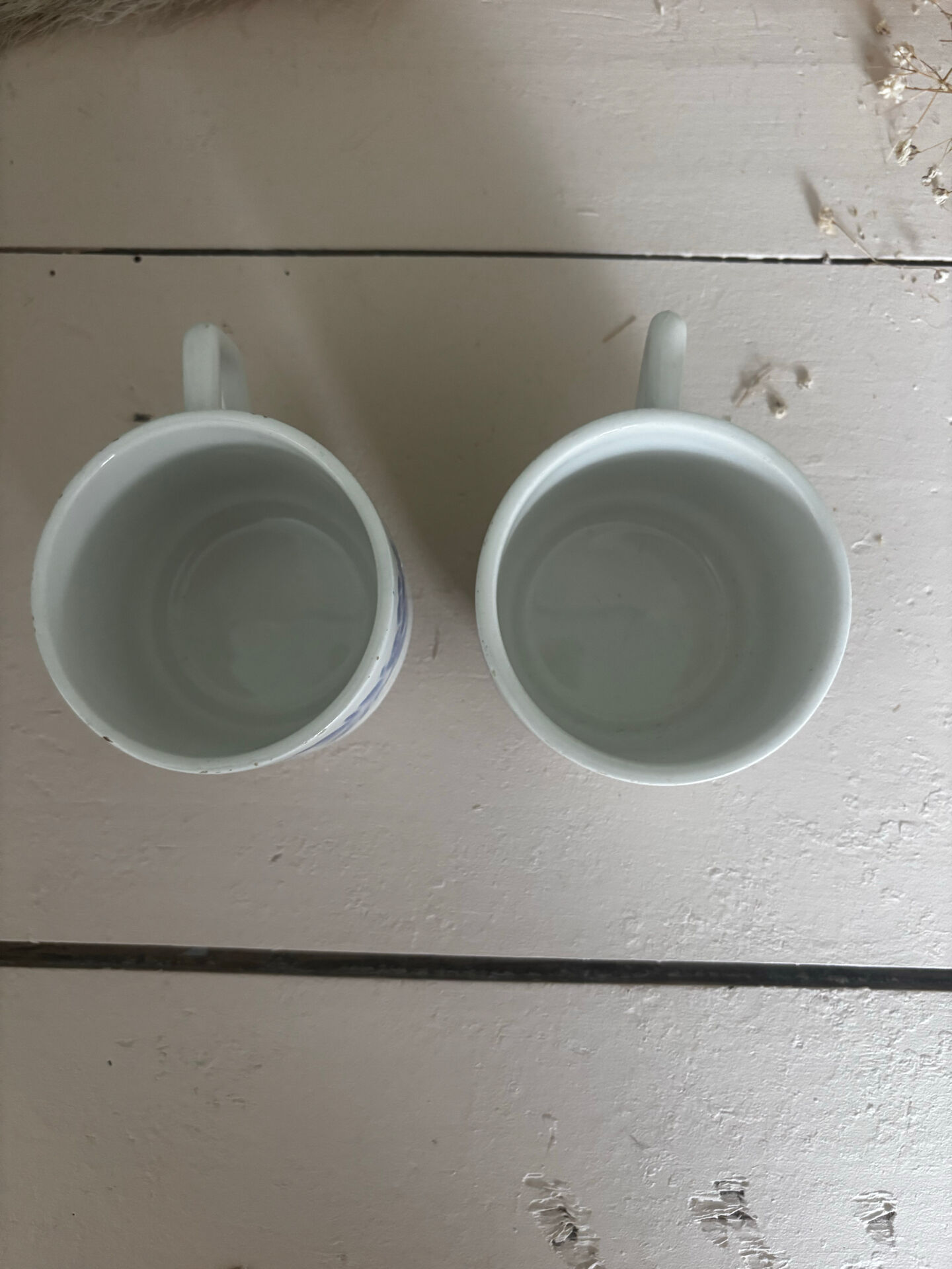 Set of 3 antique ceramic cups with blue floral pattern.